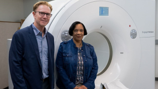 Dr. Sterling Johnson standing with a CLARiTI study participant
