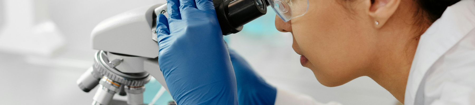 A photo of a researcher looking into a microscope