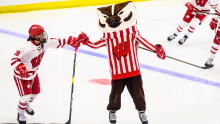 Bucky Badger skating with the UW Badgers Women's hockey team