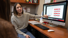 Wisconsin ADRC Developmental Project award recipient Rachael Wilson reviews research data displayed on a computer monitor in an office.